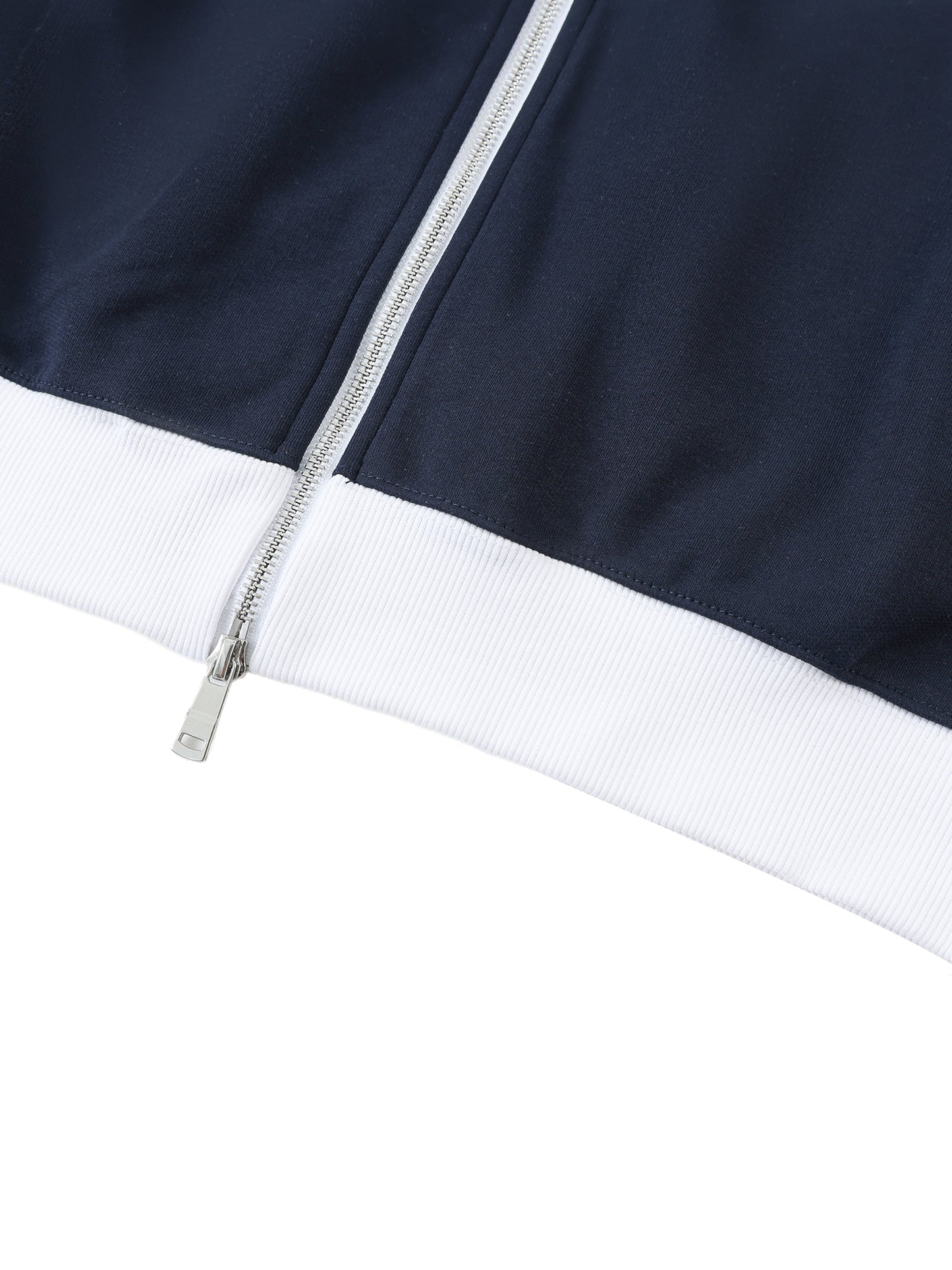 Close-up of a navy blue jacket with a white trim and zipper on a white background