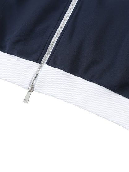 Close-up of a navy blue jacket with a white trim and zipper on a white background