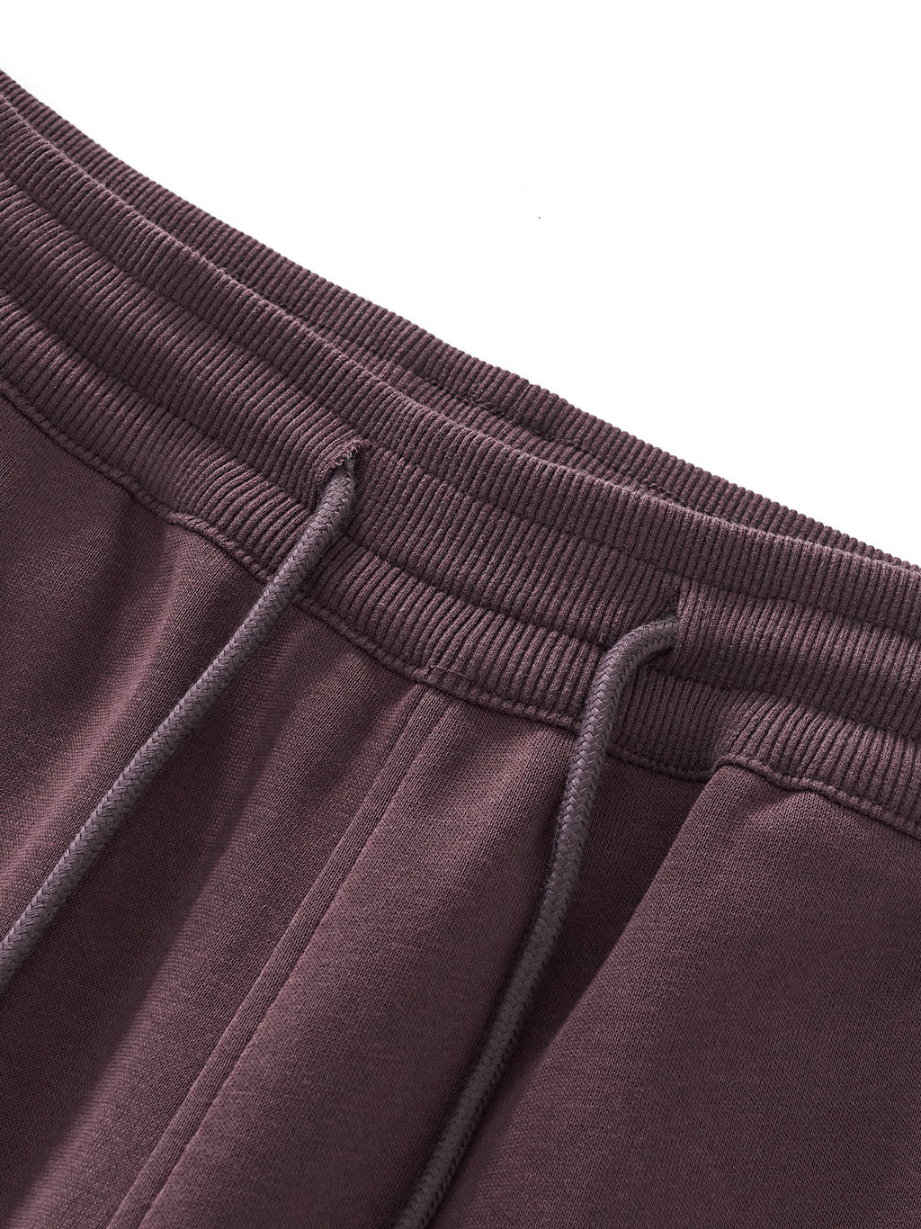 Close-up of brown sweatpants with drawstring on a white background