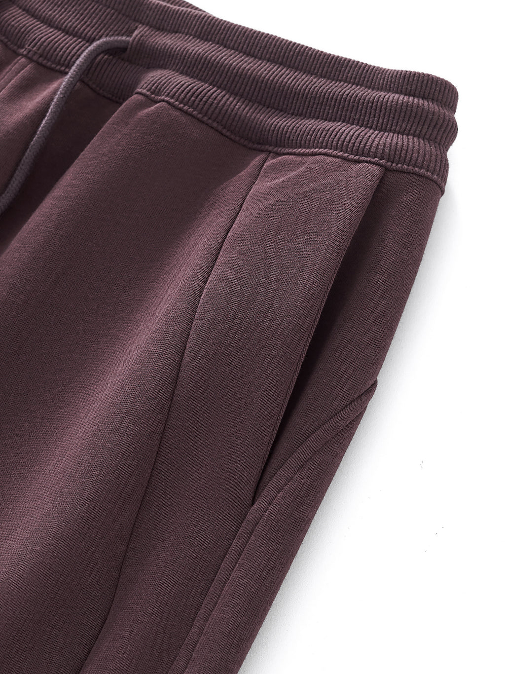 Close-up of maroon sweatpants on a white background